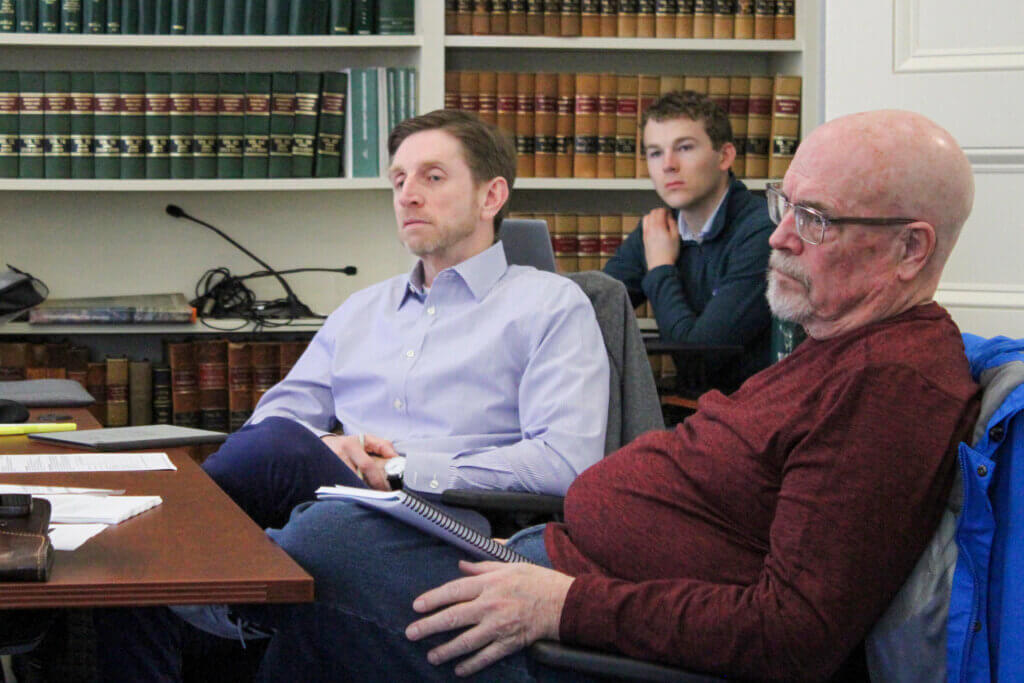 Financial Audit Advisory Committee members Breht Feigh, left, and Bruce Button, right, listen to a presentation during a March 9 meeting. Photo: Dakota Antelman/The Acton Bridge