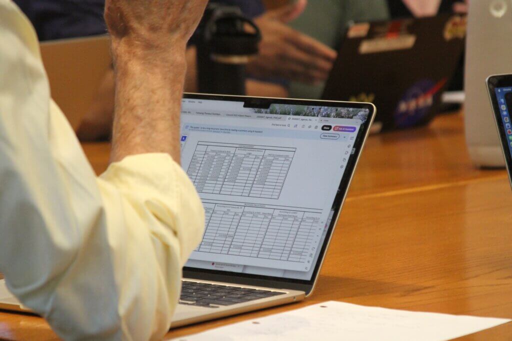 FAAC member Court Booth reviews cash reconciliation charts. Photo: Dakota Antelman/The Acton Bridge