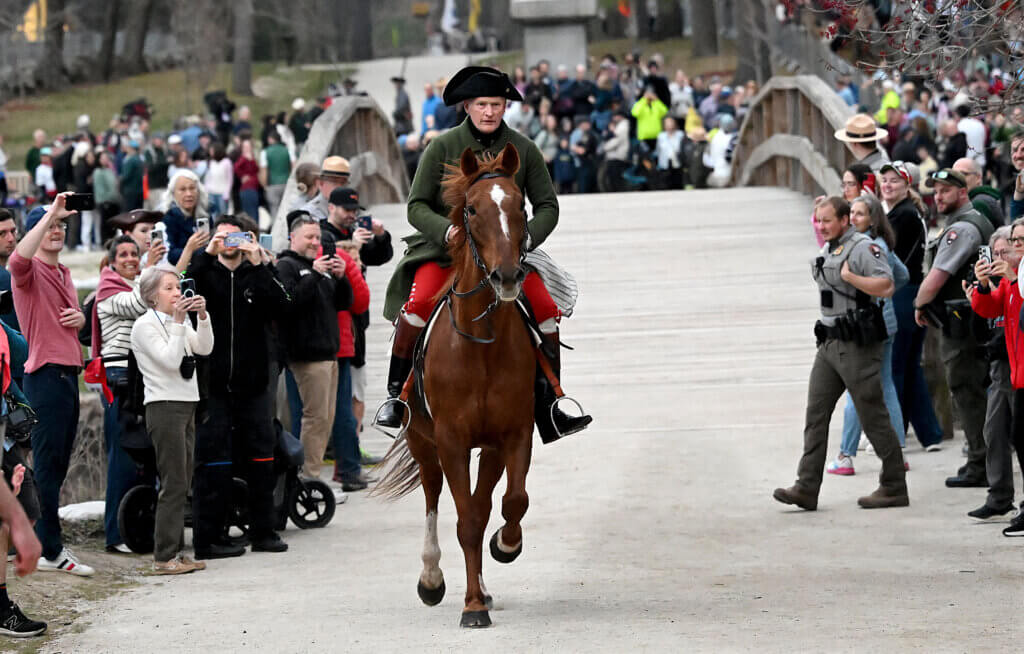 Dr. Samuel Prescott re-enactor Frank D. Bradford II rides across North Bridge during the Dawn Salute. Prescott reached Acton to warn of the advancing British troops. Paul Revere did not. Photo: Ken McGagh/The Acton Bridge