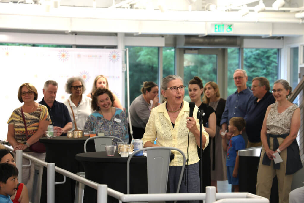 Juror Susan Swinand speaking at the exhibit’s opening. Photo by Gregory Ciccarelli