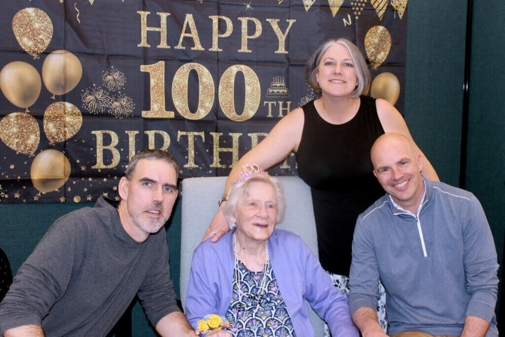 Fran’s step-grandchildren Bryan McGovern and Tara McGovern Fersko, and John Nies pose with their kindergarten teacher, Fran Gardella. Photo by Dorie Mansen
