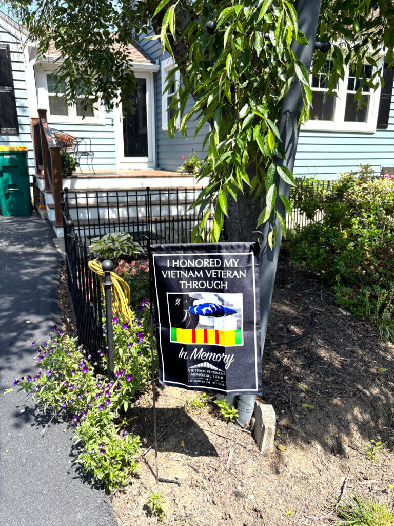 The In Memory flag outside Nancy Gresham’s Acton home. Photo: Christine M. Quirk/The Acton Bridge