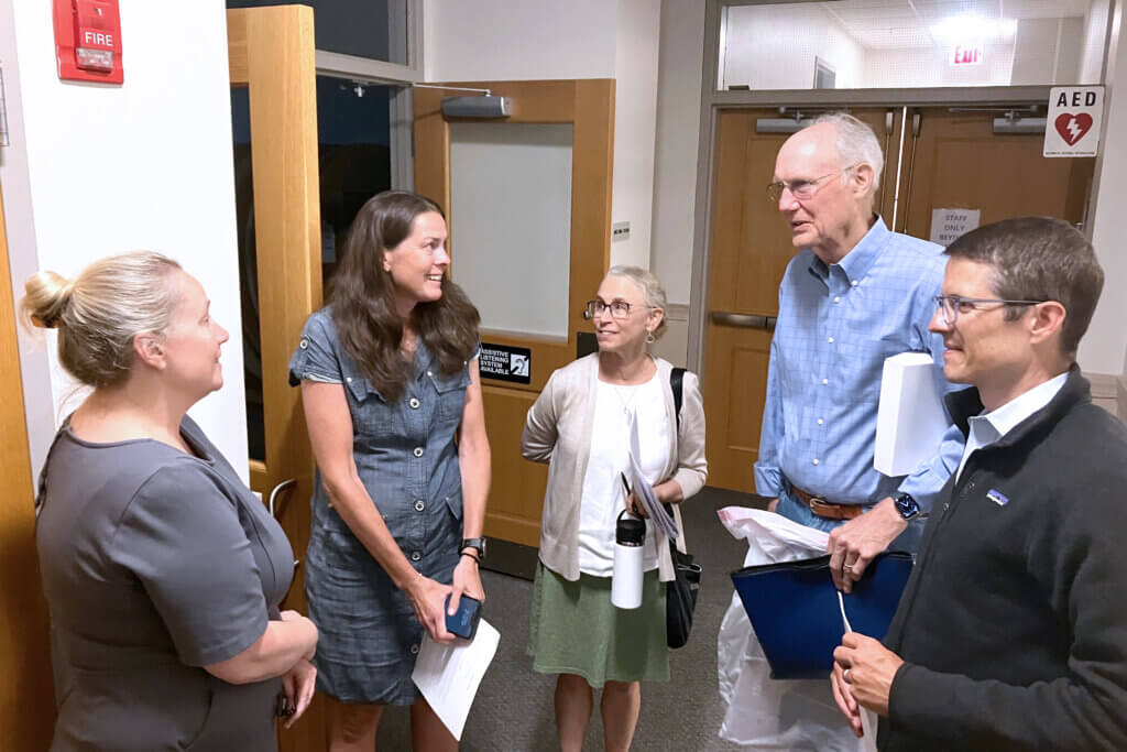 From left to right, Assistant Town Manager Jess Porter, Betsy O’Donnell, Tracey Bird, Lowell “Sandy” Smith, and Christoph O’Donnell gather in a hallway following a Recreation Commission meeting last week. Photo: Dakota Antelman/The Acton Bridge