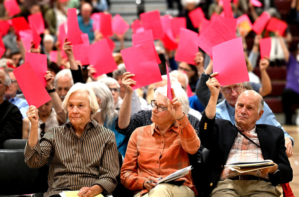 Acton residents vote in favor of Article 13 during Town Meeting at Acton-Carlisle High School, April 29, 2024. Photo: Ken McGagh/The Acton Bridge