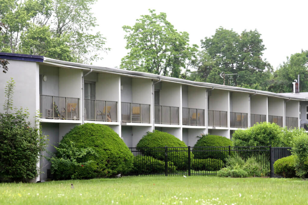 Balconies at the former Best Western Historic Acton that were once full of personal belongings are increasingly empty as the state winds down shelter operations at the site. Photo: Dakota Antelman/The Acton Bridge