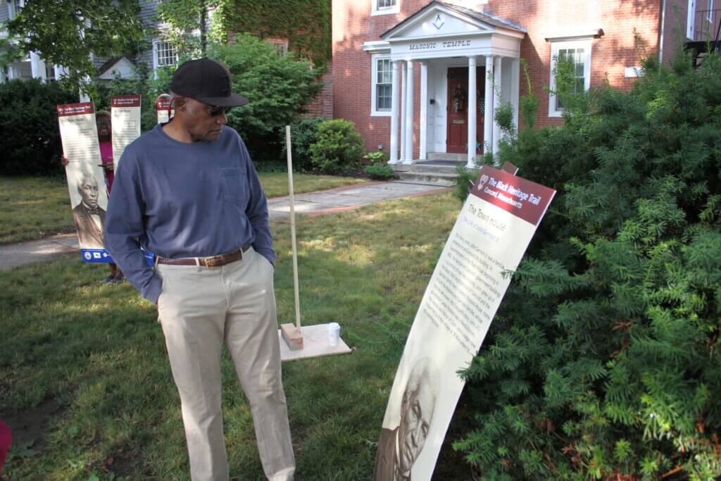 Robbins House interpreter Joe Zellner examines a proposed Black Heritage Trail Marker sign. Photo: Dakota Antelman/The Acton Bridge