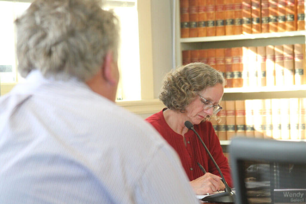 Select Board member Wendy Rovelli listens while Old Marlboro Road resident Jim Jackson speaks on May 13. Photo: Dakota Antelman/The Acton Bridge