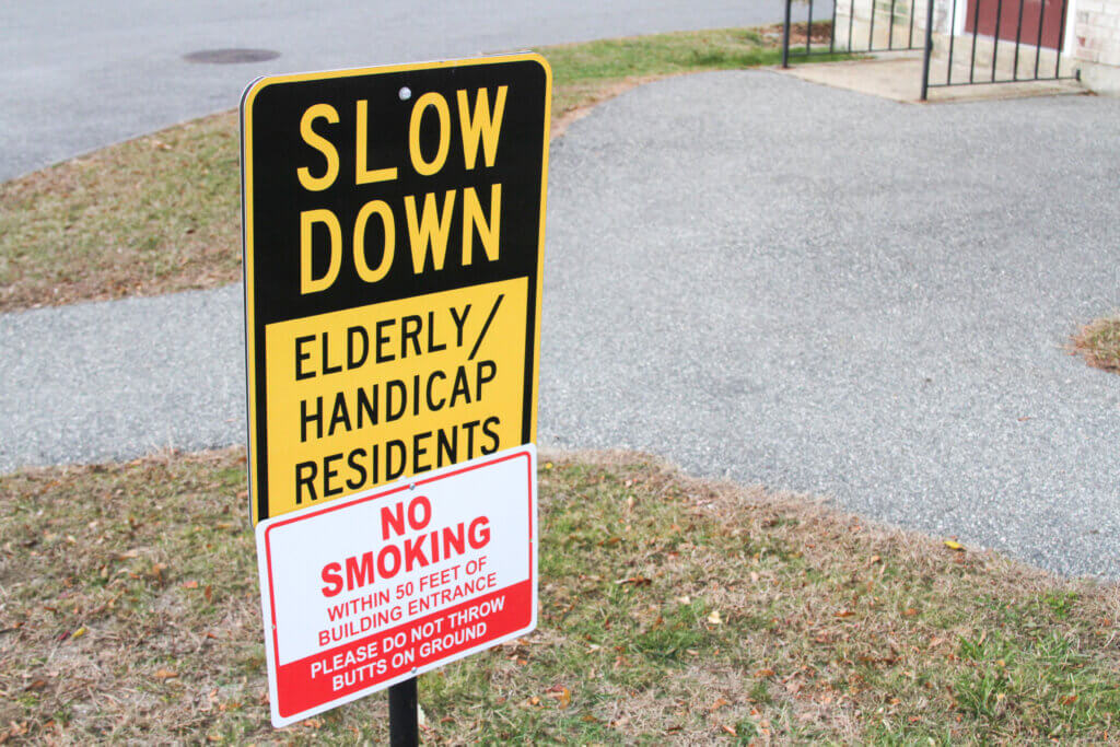 A sign urges visitors to the Everett Gardens and Everett Gardens Expansion complex to slow down. Photo: Dakota Antelman/The Acton Bridge