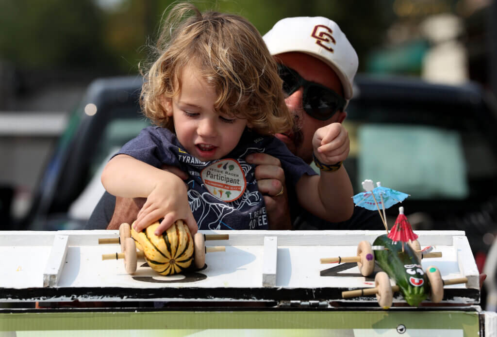 Concordian Eamon Judge, 3, launches his veggie racer onto the Scimone Farm Speedway track with help from his father, James Judge. Photo: Ken McGagh/The Acton Bridge 