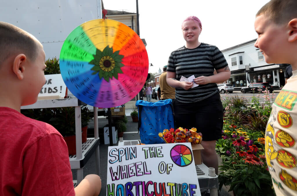 Jordan Jarvi of Colonial Gardens and youngsters at the “Wheel of Horticulture.” Photo: Ken McGagh/The Acton Bridge 
