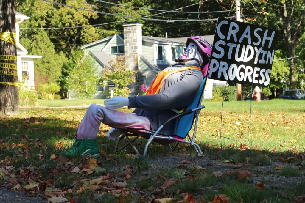 A handmade helmeted figure sits next to Upland Road in an attempt to slow down traffic in the neighborhood. Photo: Trace Salzbrenner/The Acton Bridge