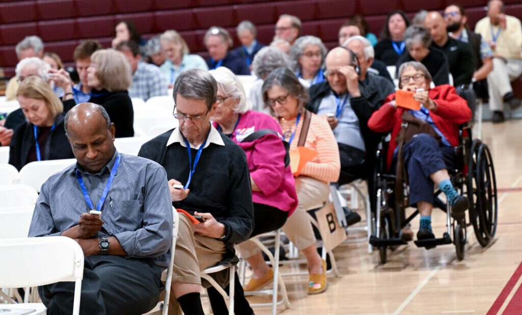 Town Meeting attendees use their clickers to weight in on funding an amenities building at Acton-Carlisle High School’s Memorial Field. Photo: Ken McGagh/The Acton Bridge