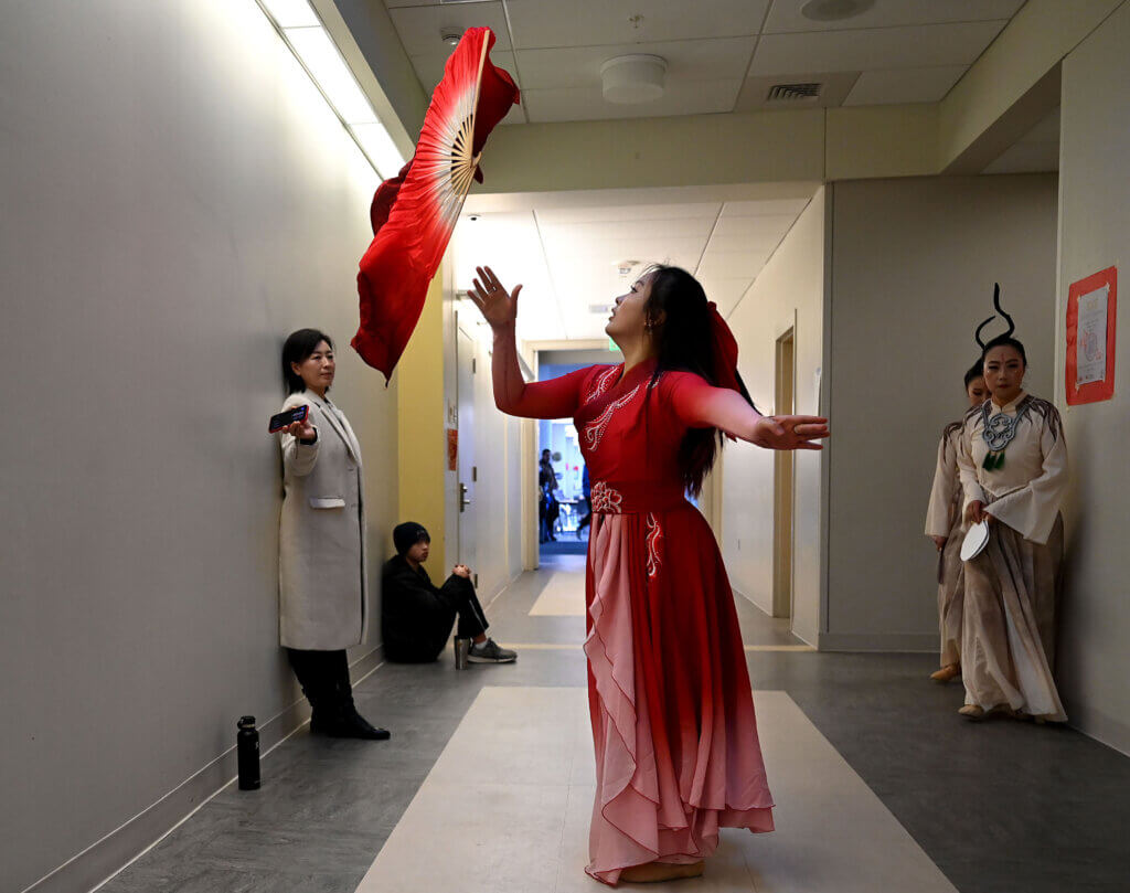 Acton-Carlisle High School student Youyang Hao, 15, warms up for her “Intoxicated by Peace Fan Dance.”