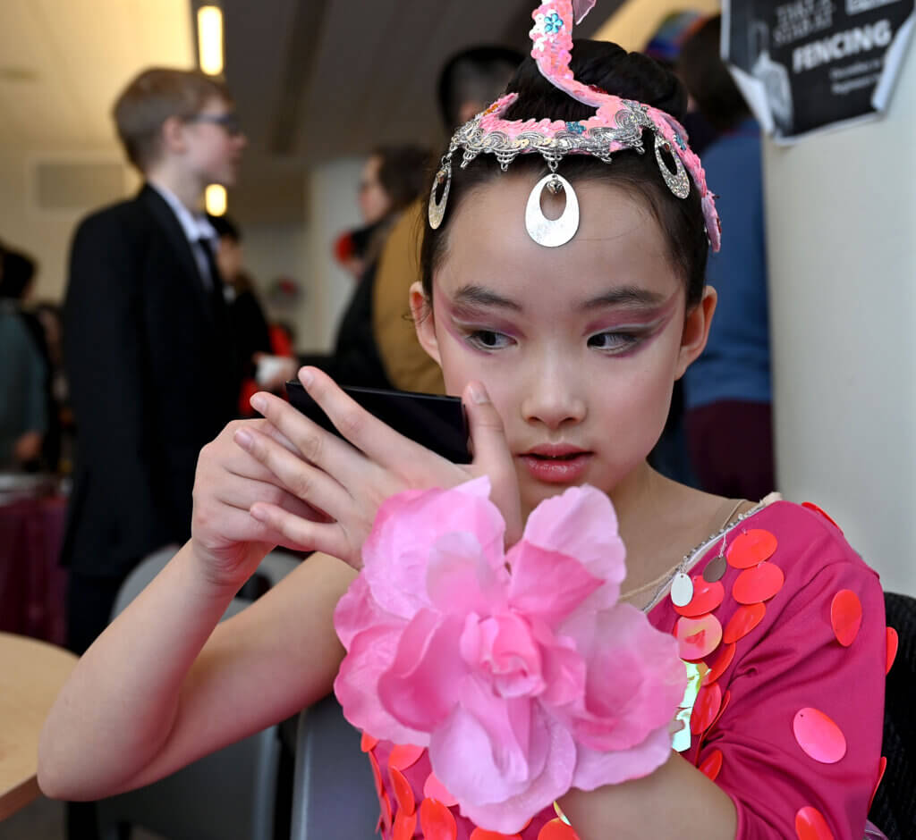 Amelia Qin, 9, of Carlisle, checks her makeup.