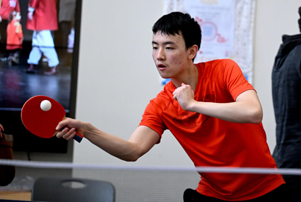 Dylan Yang, 16, a member of the CCHS Ping Pong Club, plays during the Lunar New Year Festival.