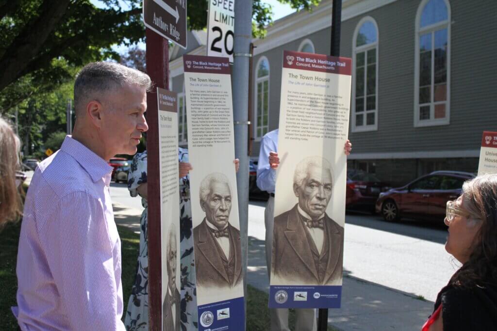 Black Heritage Trail Marker designer Ed Malouf, left, presents signs in three widths for the Historic Districts Commission to review. Photo: Dakota Antelman/The Acton Bridge