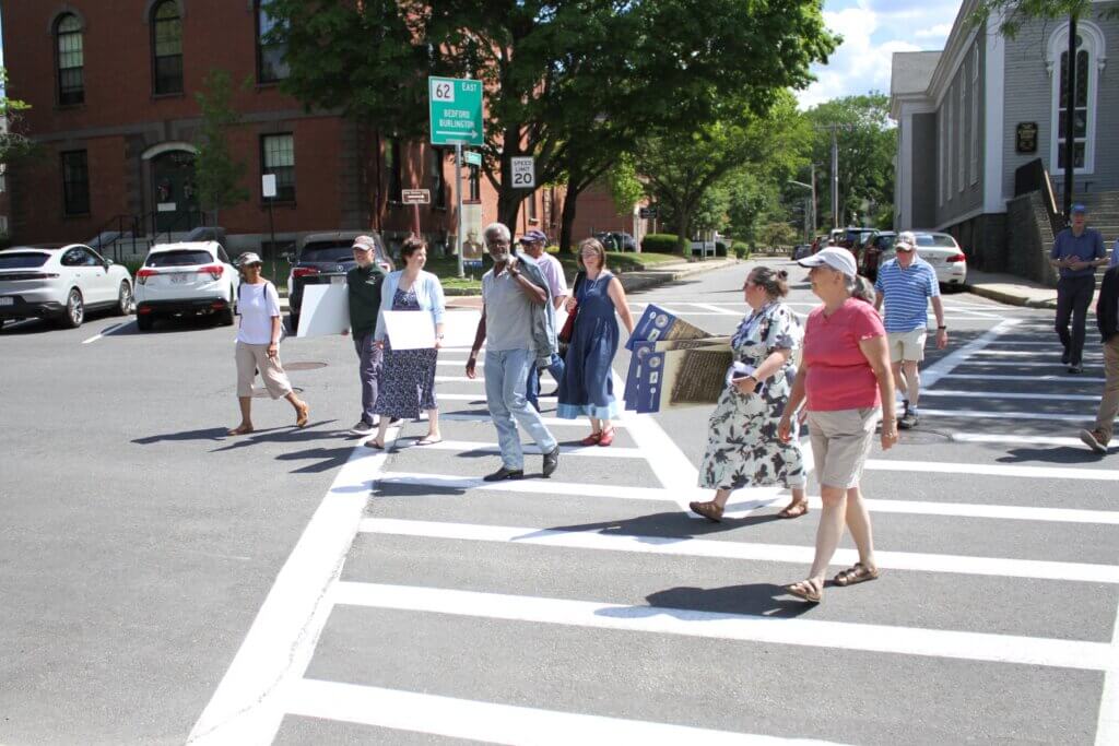 Trail marker supporters cross Monument Square during a site visit. Photo: Dakota Antelman/The Acton Bridge