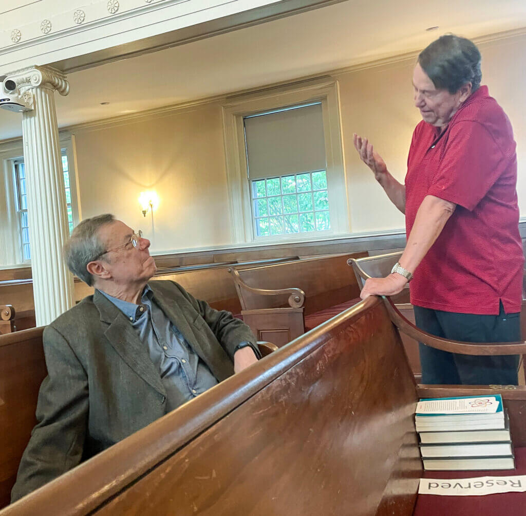 Rev. Jim Sherblom, right, speaks with Acton historian Victor Curran at First Parish. Photo by Fiona Stevenson