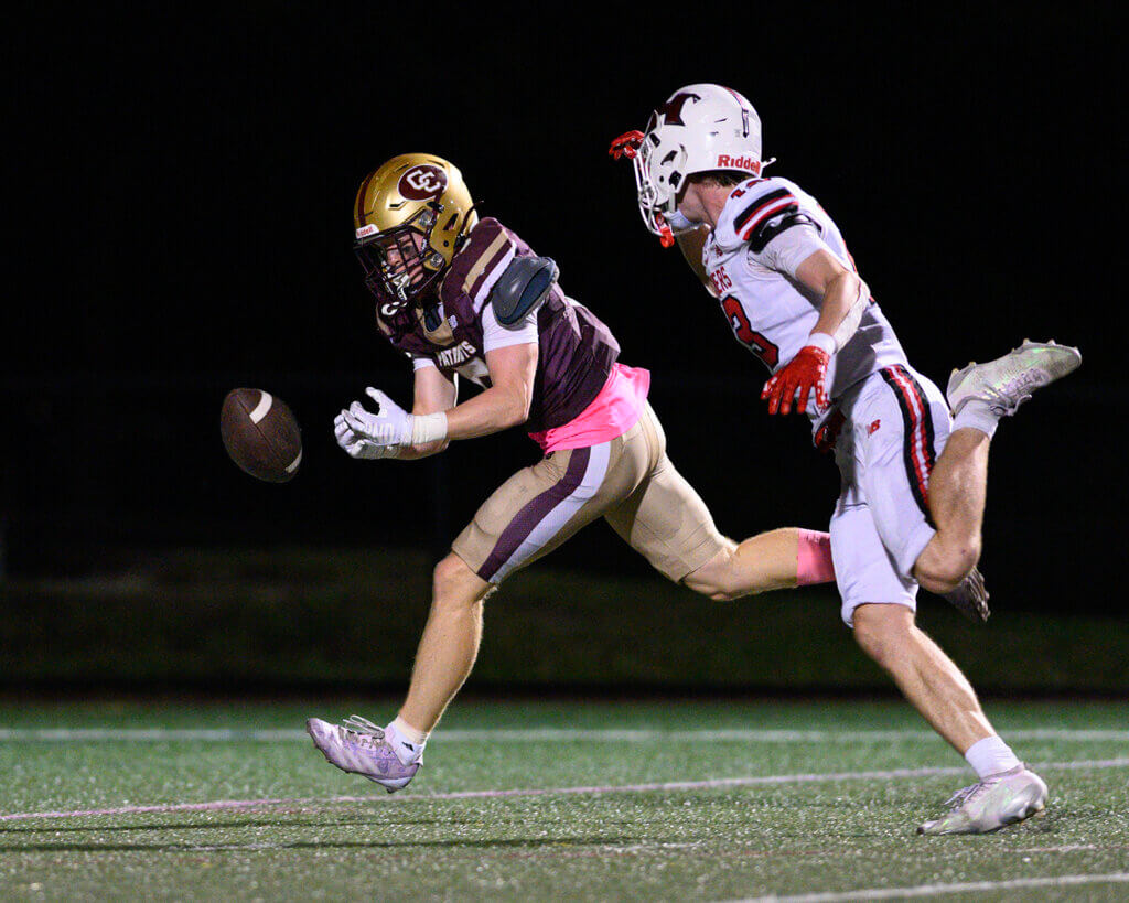 The Patriots’ Jack Garofalo tries to pull in a pass with Holliston’s Nick Flannery defending. Photo by Jon Straggas
