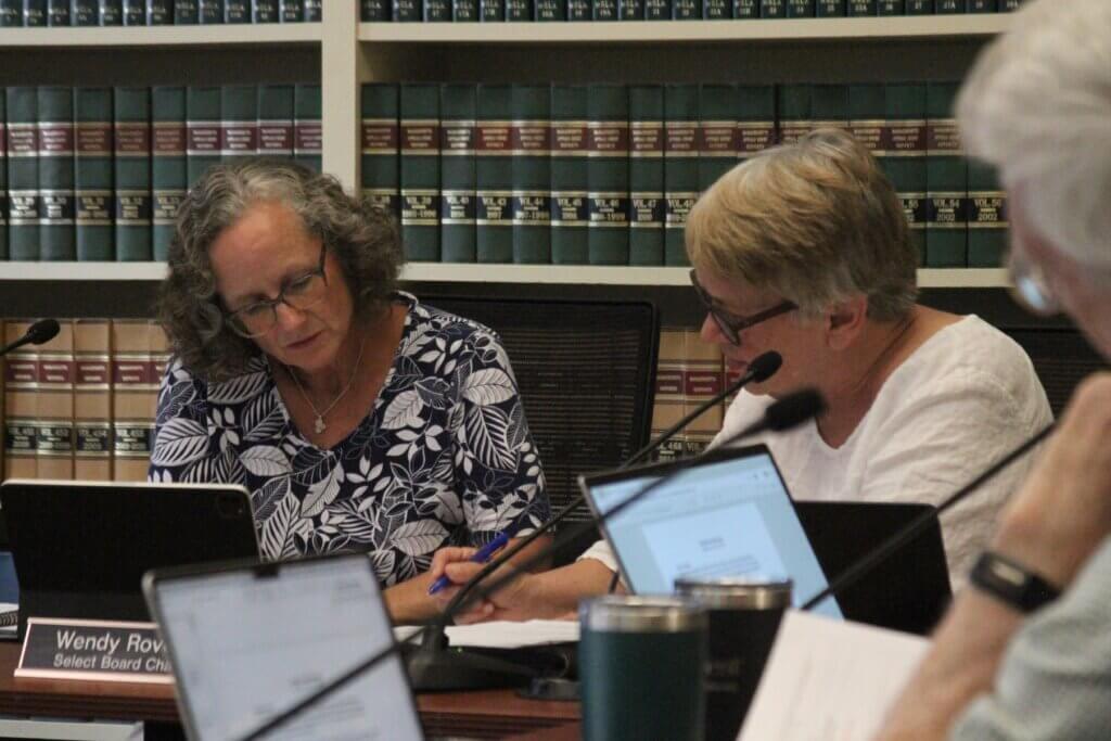 Select Board Chair Wendy Rovelli, left, and member Mary Hartman, right, review materials. Photo: Dakota Antelman/The Acton Bridge
