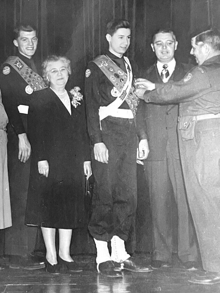 As his mother looks on proudly, Stoddard, center, receives his Eagle Scout medal in 1952. Courtesy photo