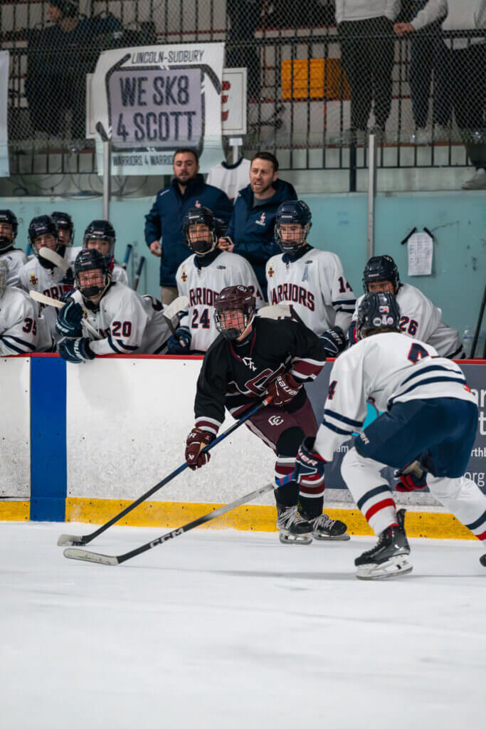 Acton-Carlisle senior Owen Moynihan (in black) outskates a Lincoln-Sudbury defenseman. Photo by Aidan Moroney