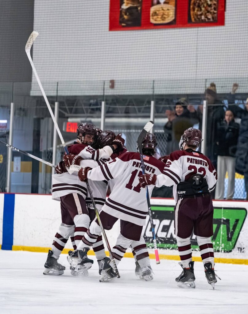 The Patriots celebrate after a crucial goal against Boston Latin on Saturday night. Photo by Aidan Moroney