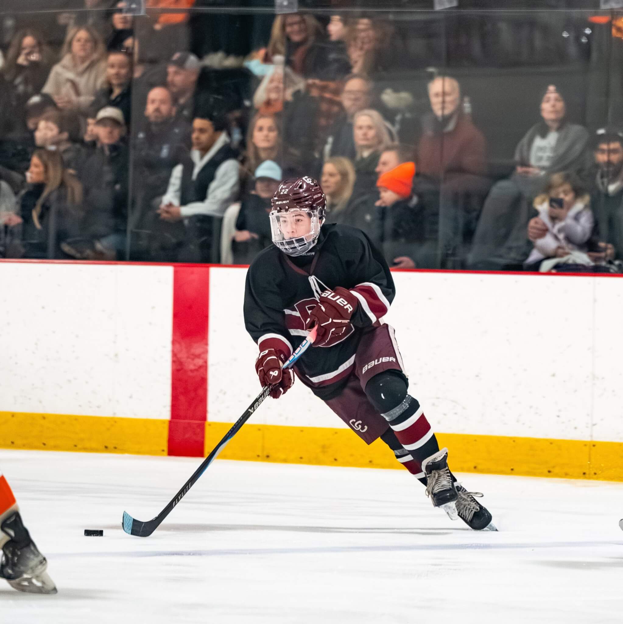 Ben Brooks carries the puck through the neutral zone during Acton-Carlisle's 2-1 win against Woburn at O'Brien Rink on Saturday. Brooks rocketed a slap shot for the game-winning goal. Photo by Aidan Moroney