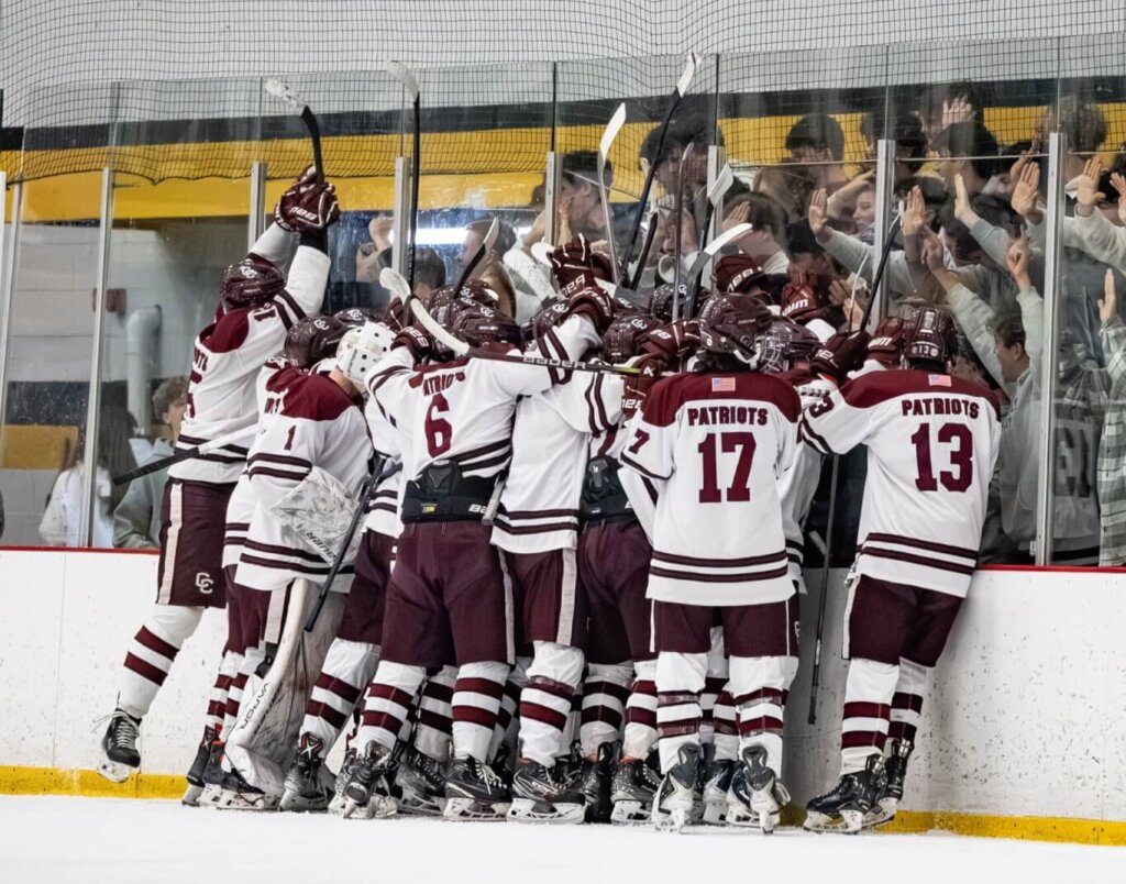 Patriots players gathered at the boards to celebrate the win over Melrose with the packed and spirited CCHS student section. Photo by Aidan Moroney