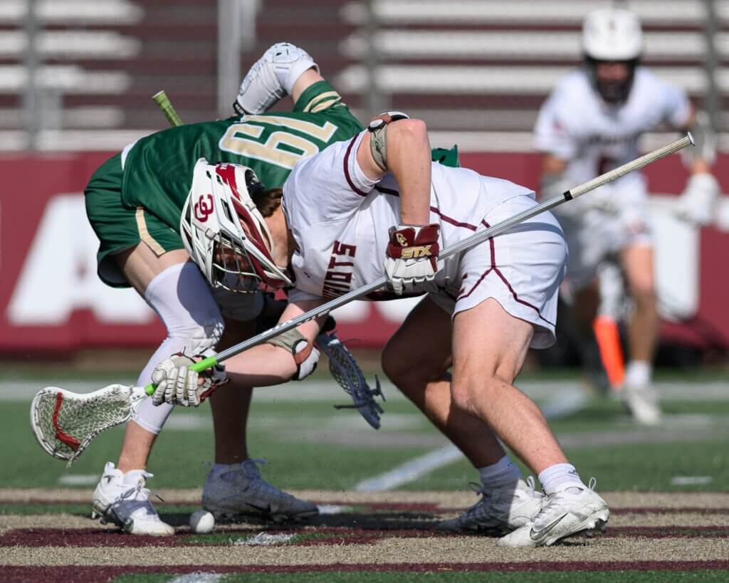 Acton-Carlisle’s Sam Griswold (No. 1) faces off against Nashoba Regional’s Evan Yagodzinski (No. 19) on April 28. Photo by Jon Straggas