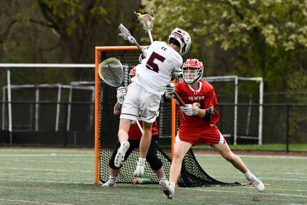 Acton-Carlisle’s John Anderson (No. 5) shoots against Waltham on April 30. Photo by Cris Van Dyke