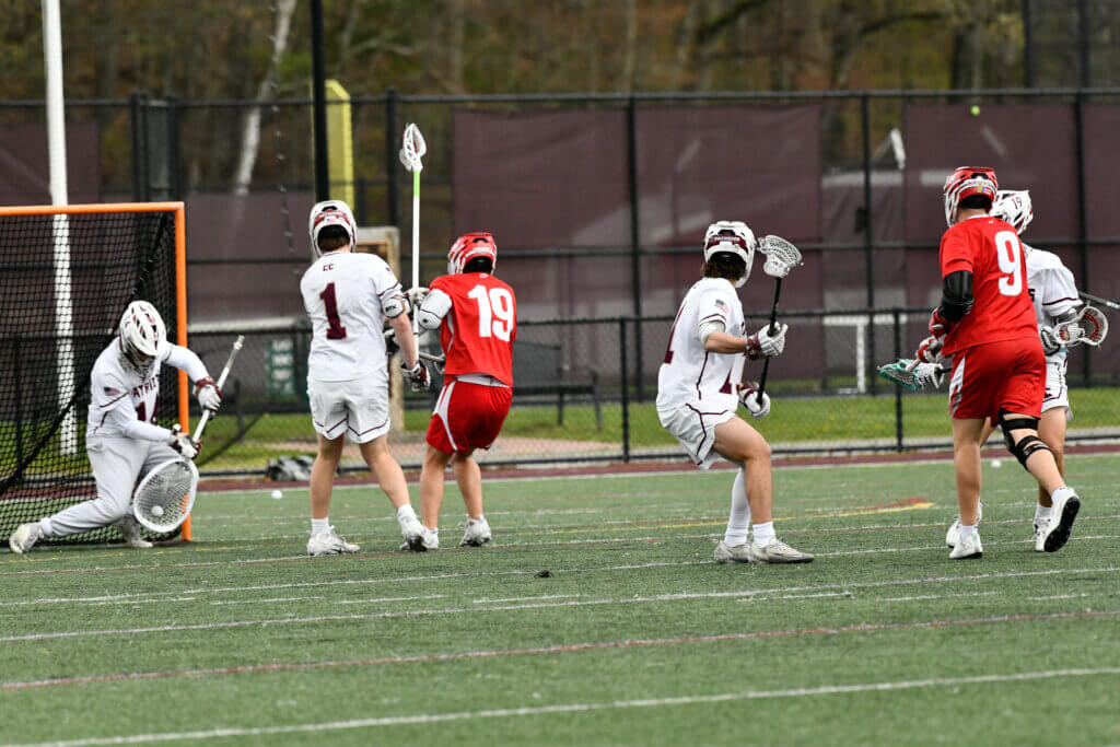 Patriots goalie Ben Wonsek (No. 14) makes a save en route to holding Waltham to just four goals on April 30. Photo by Cris Van Dyke