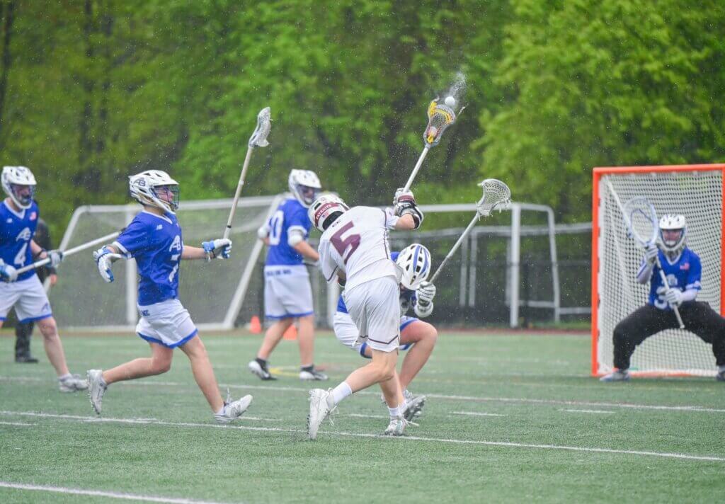 Acton-Carlisle’s John Anderson fires a shot on goal against Acton-Boxborough on May 14. Photo by Henry Morgan