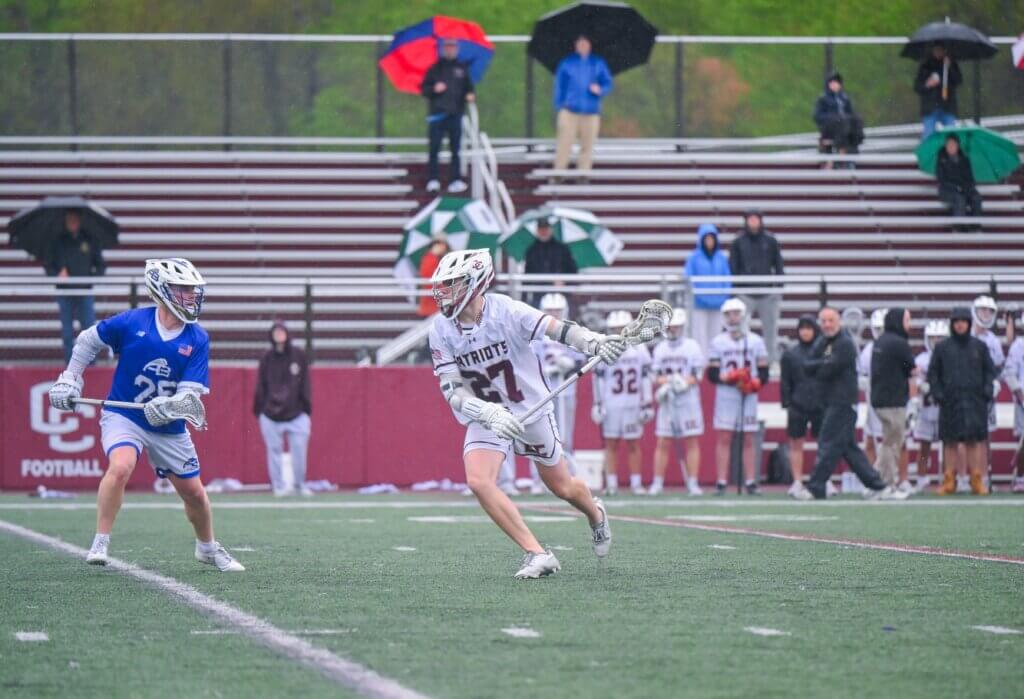 The Patriots’ Alex Kosicki drives to the net against Acton-Boxborough on May 14. Photo by Henry Morga