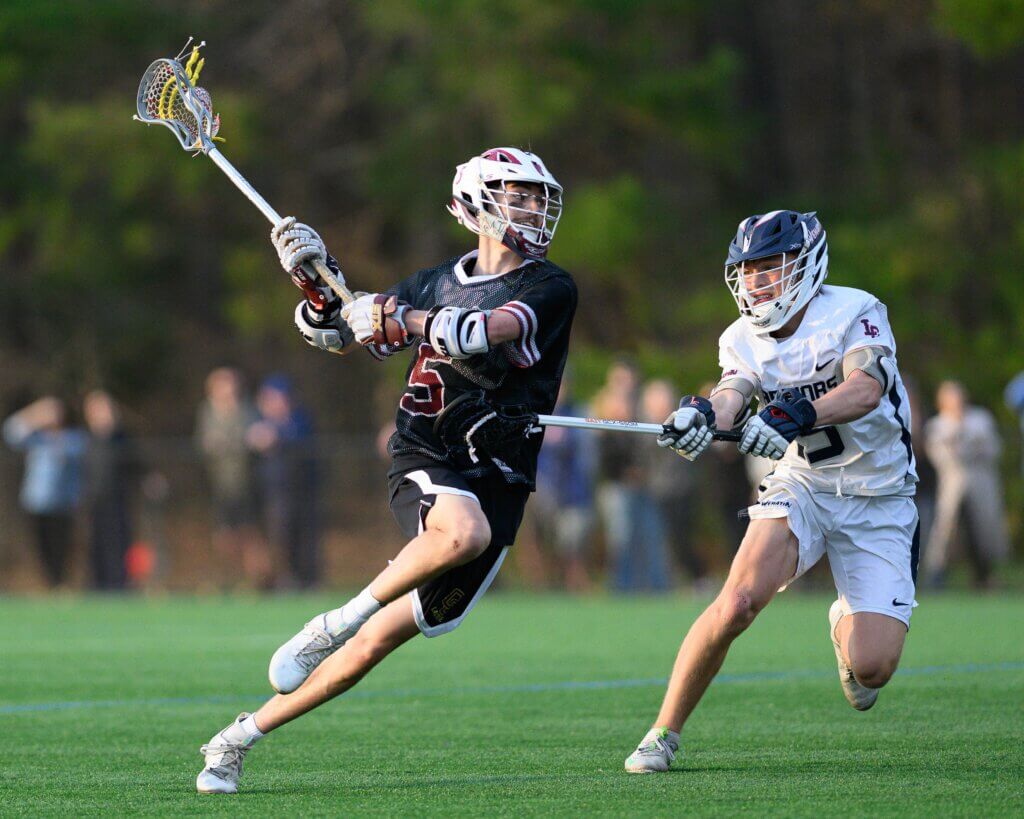 Acton-Carlisle co-captain John Anderson (No. 5) scored the Patriots’ first goal against Lincoln-Sudbury on April 16. Photo by Jon Straggas