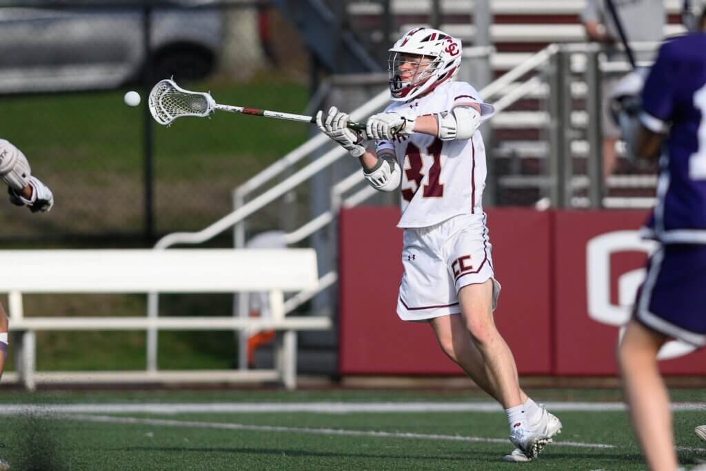 Trey Forman (No. 31) pressures the Boston Latin defense in the Patriots’ 16-3 win on April 14. Photo by Jon Straggas
