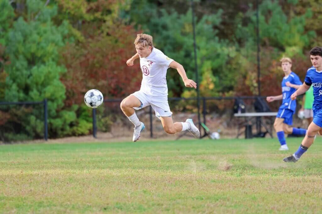 Chris Rigazio takes flight against Bedford. Photo by Janel Apuna