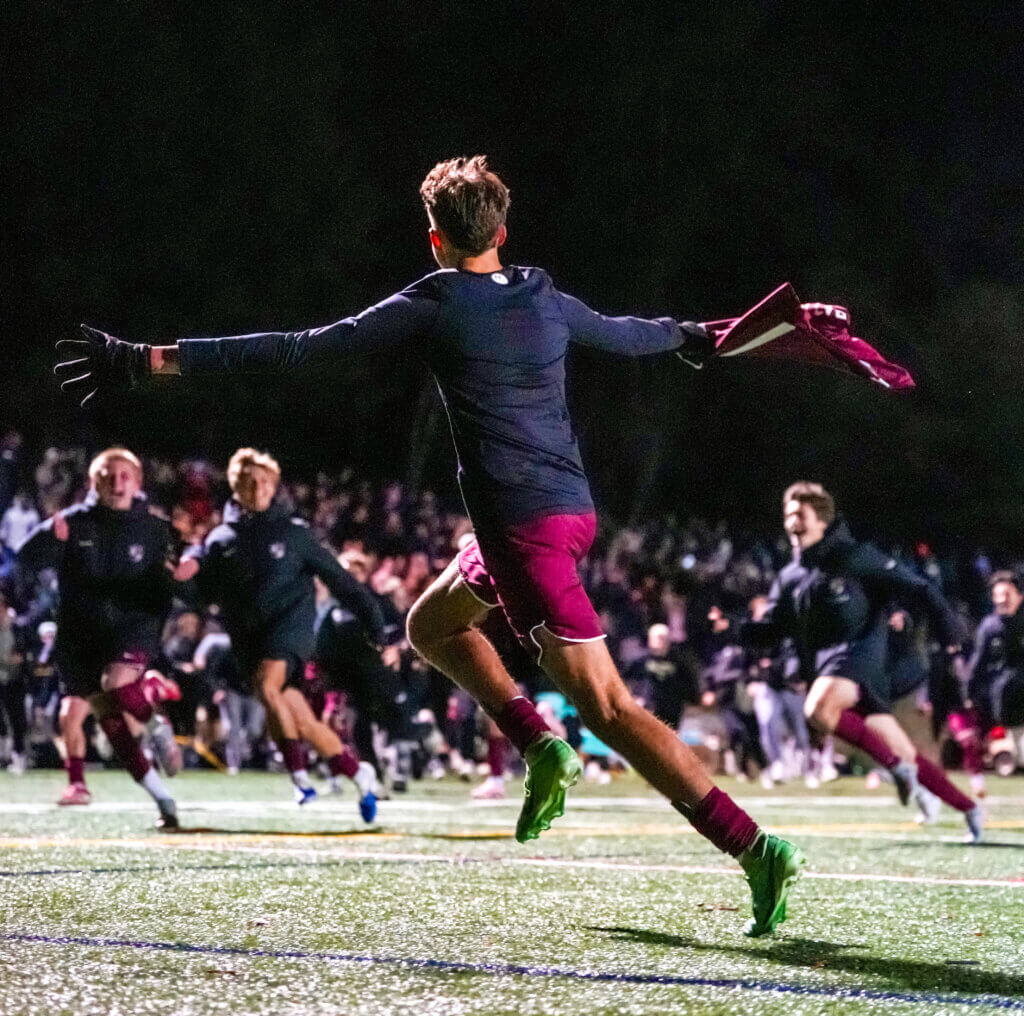 CCHS junior Max Hepworth runs towards his teammates after scoring the game-winning goal in OT. Photo by Aidan Moroney