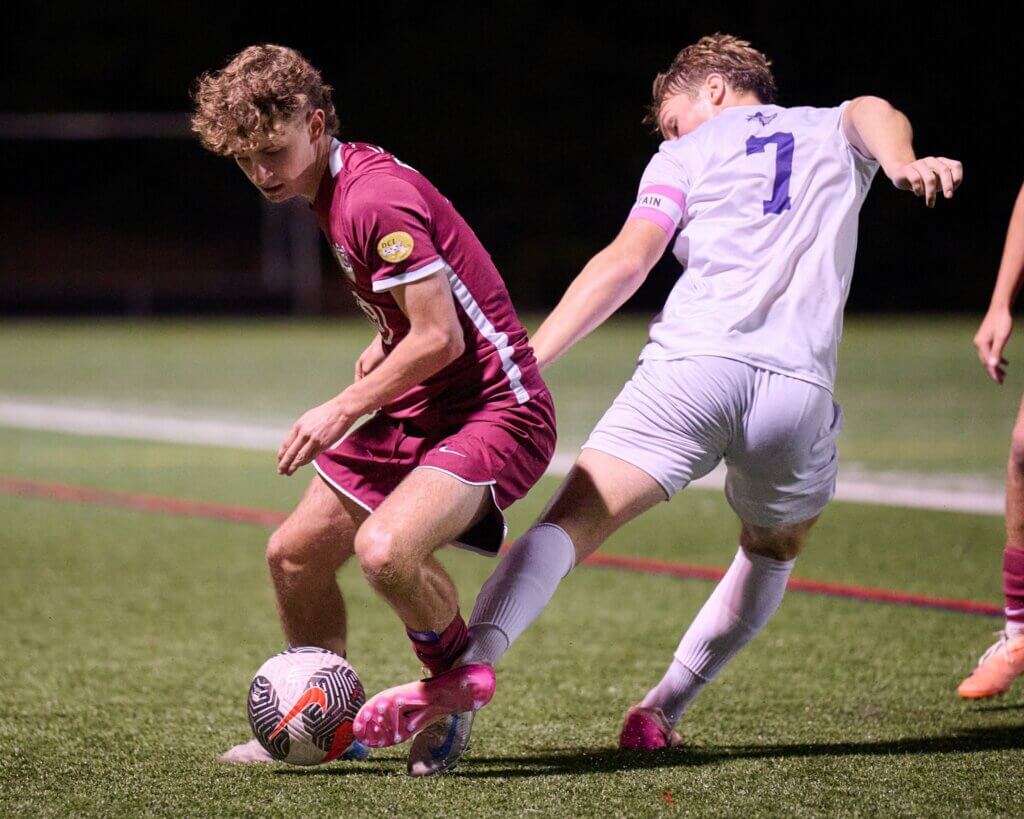 Owen Tompsett battles a Boston Latin opponent for the ball. Photo by Jon Straggas
