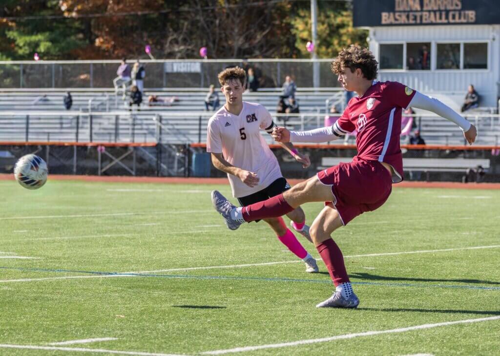 Cooper Balfour powers through the ball against Oliver Ames High School on October 25. Photo by Rebecca Woodward