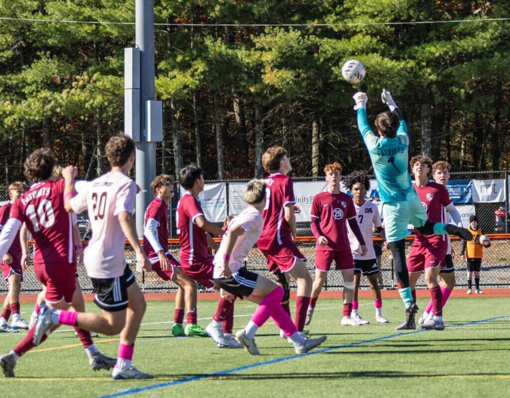 Goalie Niko Kocic skies to thwart an Oliver Ames scoring opportunity on October 25. Photo by Rebecca Woodward