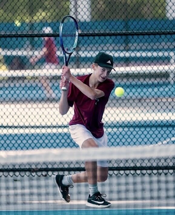 Jack McClelland en route to his 6-2, 4-6, 6-1 victory, which sealed the Patriots’ second-round win over Winchester. Photo by Alexis Guinebertiere