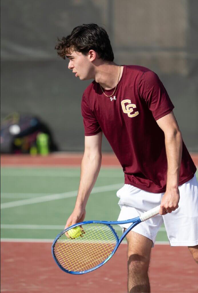 Acton-Carlisle’s Mack Rottenberg prepares to serve in his doubles match against Lexington on June 4. Photo by Alexis Guinebertiere