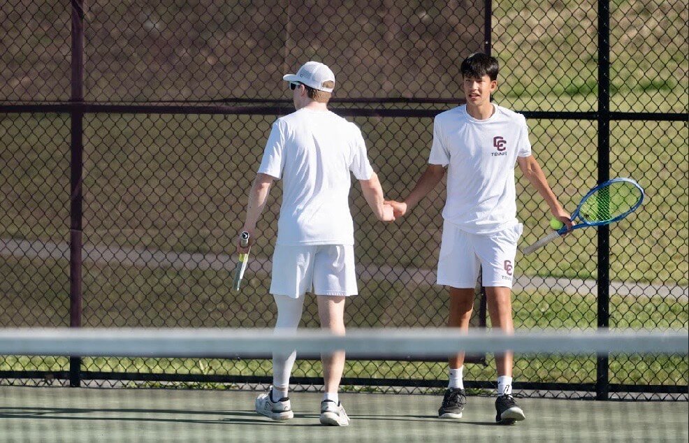 Patriots doubles partners Jack Garofalo and Austin Fischl congratulate each other after a point against Westford on May 12. Photo by Alexis Guinebertiere