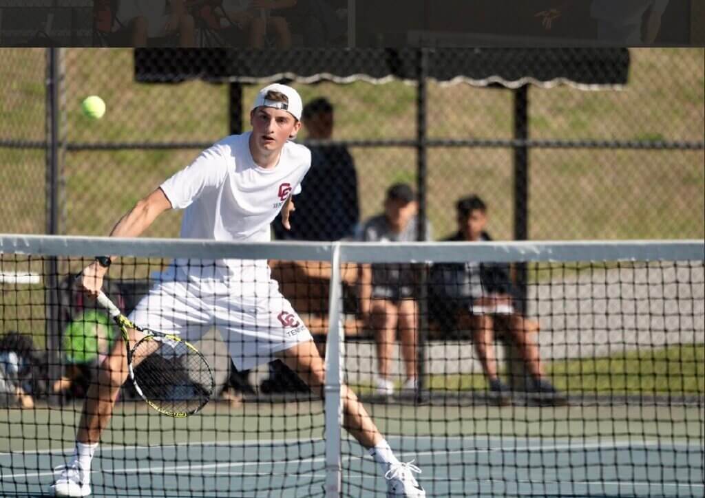 CCHS’ Brooks Miller eyes up a return during the first doubles match against Westford on May 12. Photo by Alexis Guinebertiere