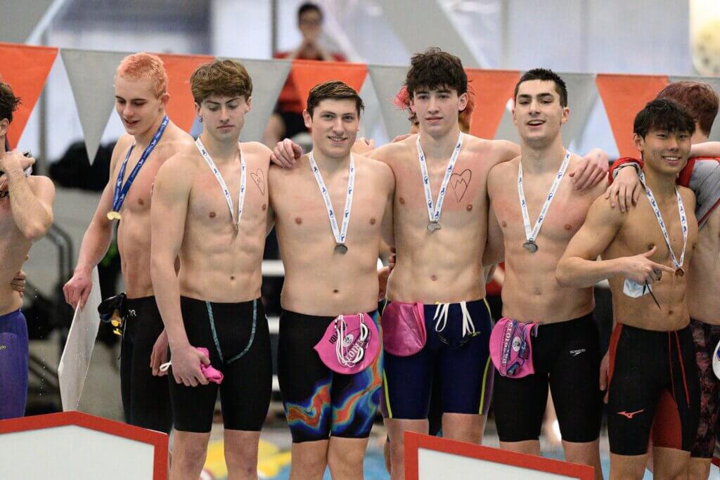 From left, Brandon Monaghan, Cole Scafidi, Andrew Hodges, and Presley Rodgers at the podium for second place in the 200 medley relay at the MIAA Division 1 Championships last Sunday. The team broke the Acton-Carlisle High School record for the third time this season with a 1.37.45 time. Photo by Jon Straggas