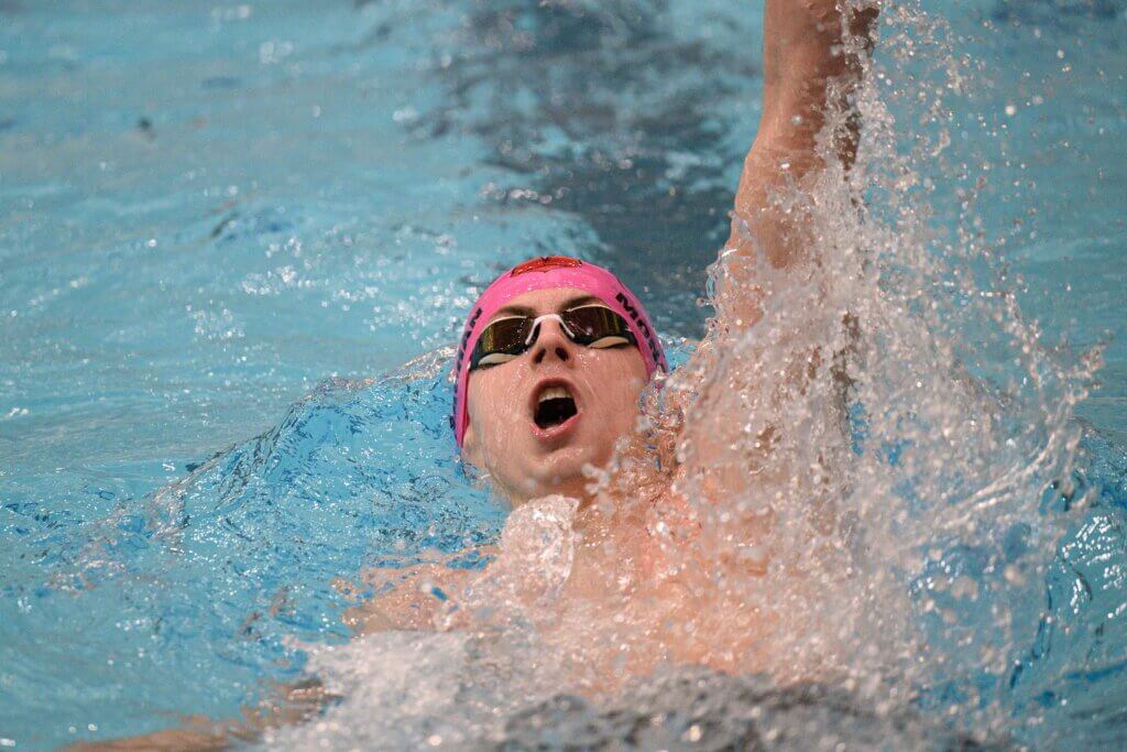 Brandon Monaghan swims the 100 backstroke at the MIAA Division 1 Championships last Sunday. Photo by Jon Straggas