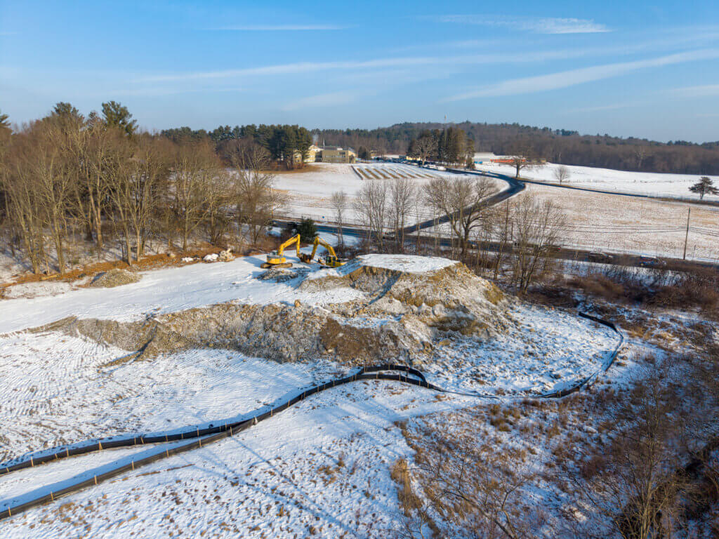 Large snow-dusted dirt piles still filled part of a town parcel near the Acton rotary last week. Photo: Carl Calabria/The Acton Bridge