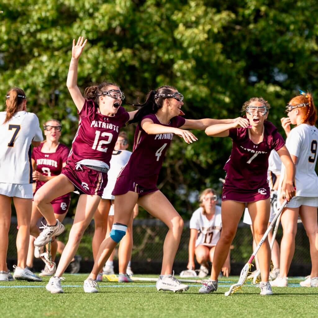 Patriots players race toward co-captain Sarah Fortier (No. 7) after she scored the winning goal in sudden death overtime to give CCHS its second straight MIAA Division 1 title. Photo by Aidan Moroney