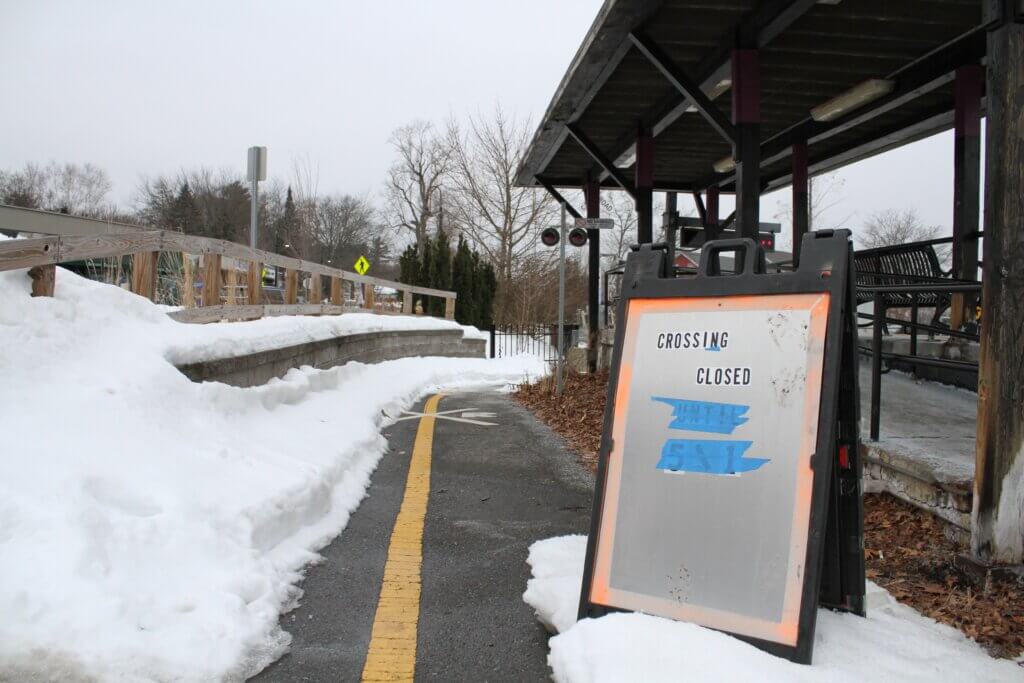 Barriers and signs went up in recent weeks blocking the Bruce Freeman Rail Trail track crossing at the West Acton Commuter Rail station. Photo: Dakota Antelman/The Acton Bridge